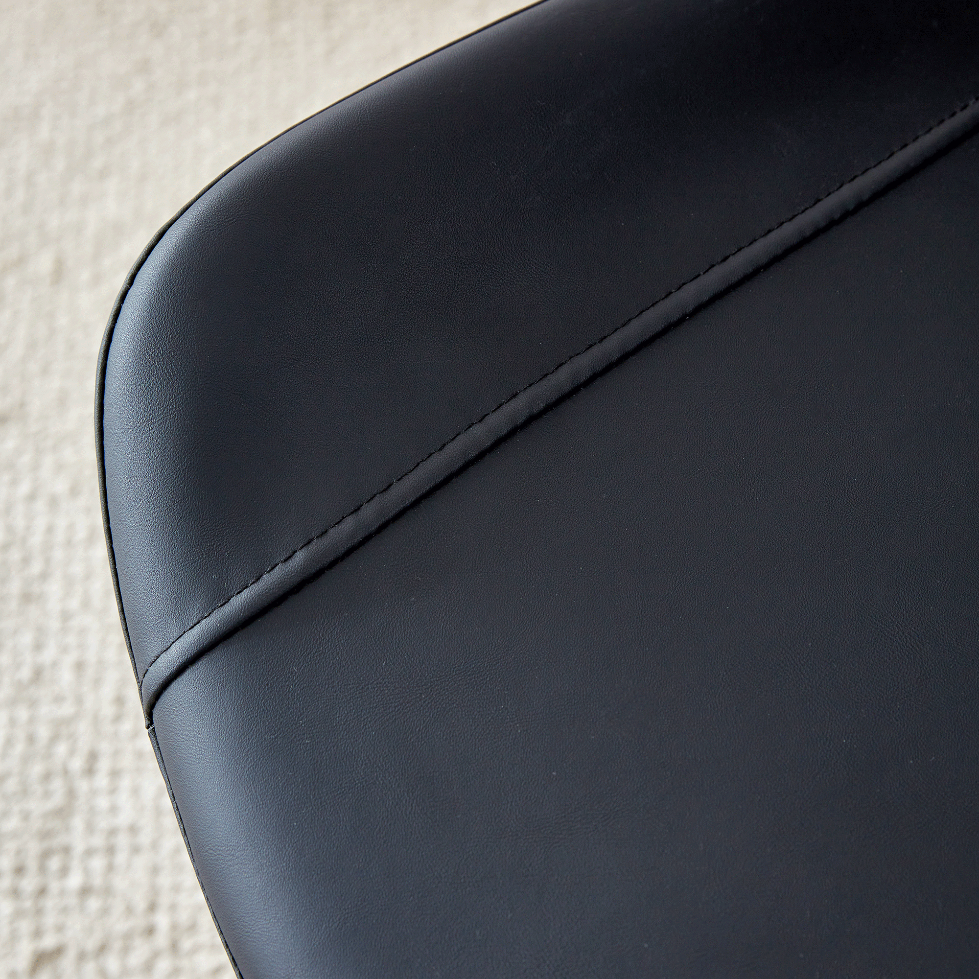 Table and chair set.A minimalist retro rectangular dining table with a specially textured top and black metal legs.Paired With 4 Black Artificial PU Chairs With Curved Widened Cushion Design.