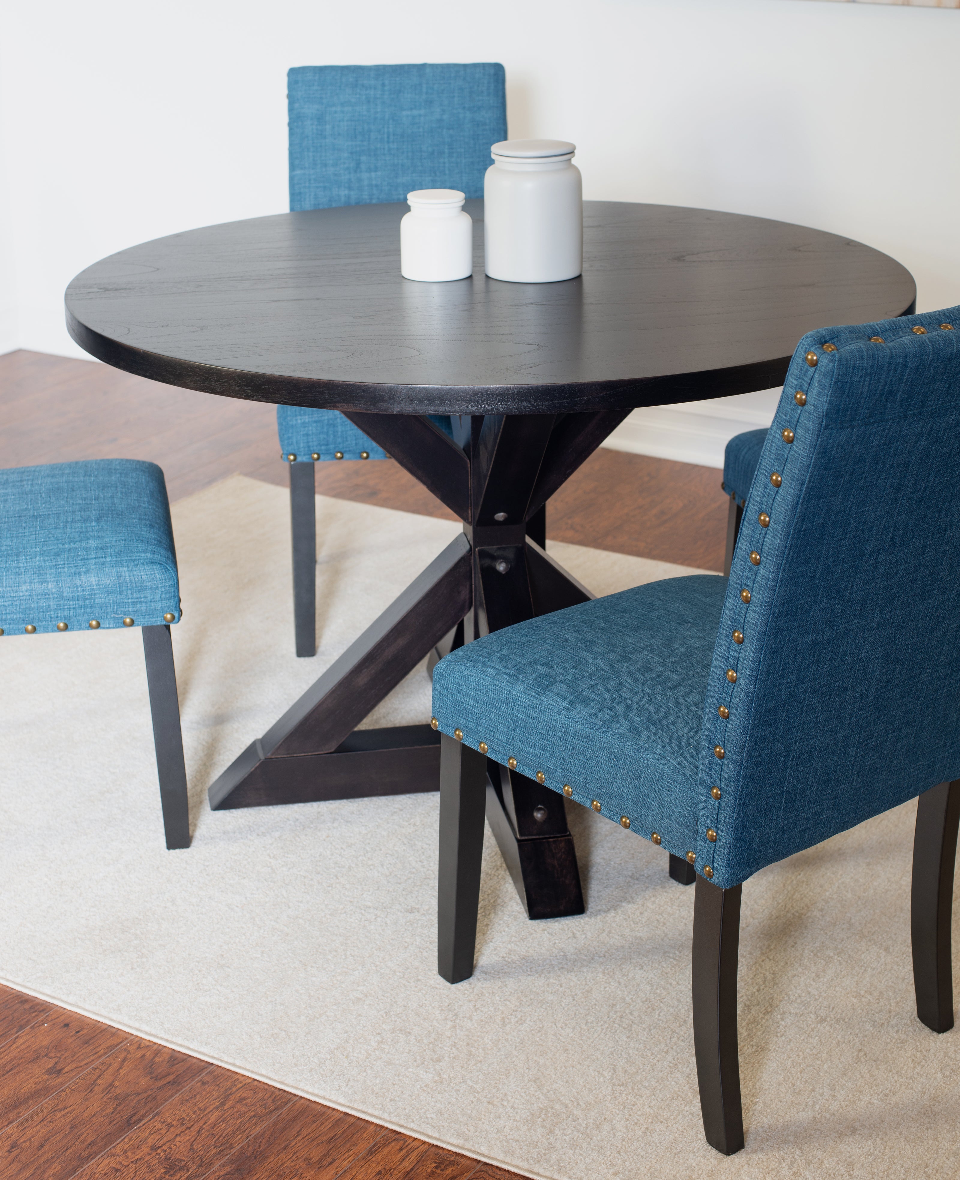 Mytzi 5-Piece Round Dining Set: Black Oak Veneer Table with Cross-Buck Base & 4 Blue Linen Chairs, Brass Nailheads, Seats 4, Durable Rubberwood Frame, Perfect for Dining Room & Kitchen