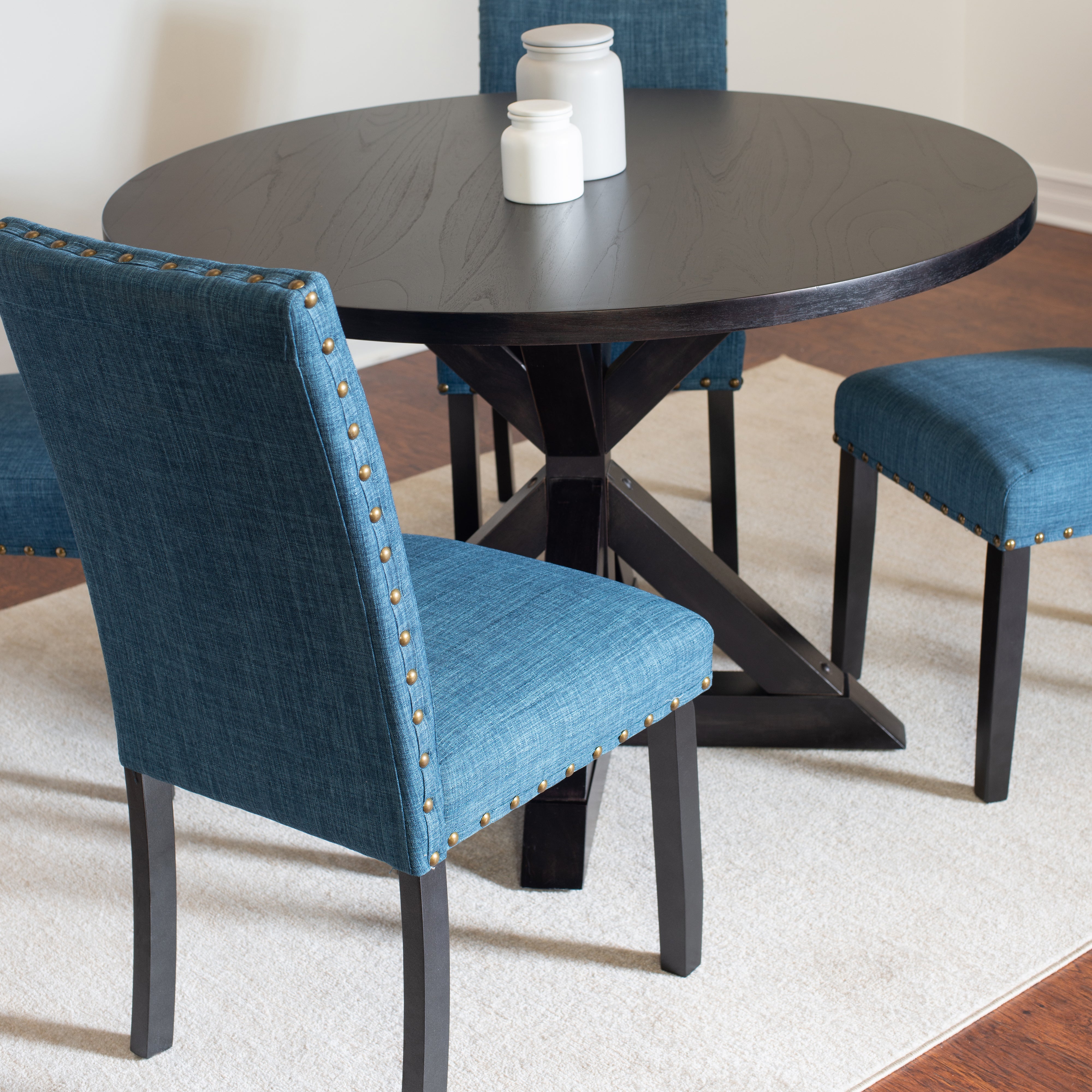 Mytzi 5-Piece Round Dining Set: Black Oak Veneer Table with Cross-Buck Base & 4 Blue Linen Chairs, Brass Nailheads, Seats 4, Durable Rubberwood Frame, Perfect for Dining Room & Kitchen