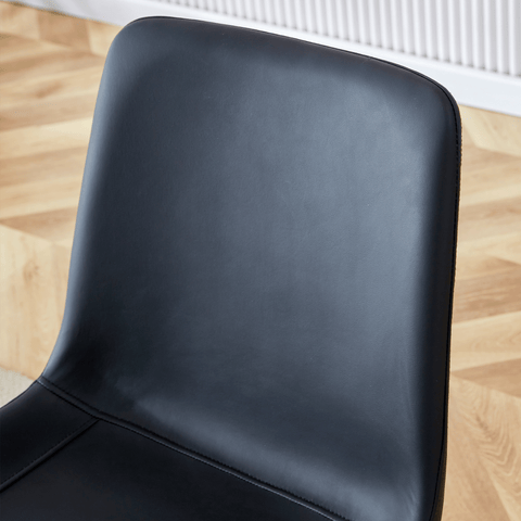 Table and chair set.A minimalist retro rectangular dining table with a specially textured top and black metal legs.Paired With 4 Black Artificial PU Chairs With Curved Widened Cushion Design.