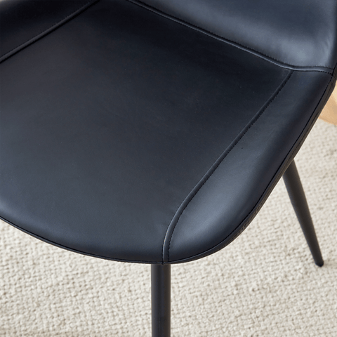 Table and chair set.A minimalist retro rectangular dining table with a specially textured top and black metal legs.Paired With 4 Black Artificial PU Chairs With Curved Widened Cushion Design.